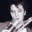 Static grayscale pixel art of a person's face and upper torso with dark hair, visible in a 48x48 icon frame against a black background.
