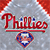 Red cursive 'Phillies' text above a horizontal red bar, with a diamond-shaped logo containing a white 'P' on a blue background below, all on a gray pixelated backdrop with red and white accents.