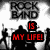 Black-and-white image with red text reading "ROCK BAND IS MY LIFE!" and a drum kit illustration below.