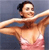 Pixelated image of a person with dark hair wearing a pink bikini top, arms extended horizontally against a blue background.