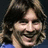 Pixelated portrait of a person with long brown hair on left, red text on blue background listing name and team details.
