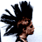 Pixelated static image of a character with spiky black hair and brown skin tones, wearing dark clothing against a white background.