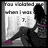 Pixelated image shows a figure in dark clothing with purple accents holding a white sign displaying partial text and a question mark.