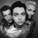 Black-and-white image of three people in a group pose, with the central figure's mouth open in an animated sequence.