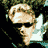 Pixelated static icon of a person with light skin tone, dark hair, and white clothing against a black background with green foliage elements.