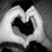 Black-and-white pixelated icon shows a stylized heart shape with a dark central void and lighter surrounding outline against a gradient background.