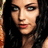 Pixelated close-up of a person with dark hair, light skin tone, and red lips against black background.