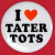Circular white icon with red border containing black text "I ❤️ TATER TOTS" in pixelated font on solid red background.