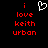 Red pixelated text 'i love keith urban' on black background with white heart symbol above text.