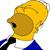 Pixelated character with yellow hair, brown face, black eye, blue clothing, and white collar against a plain background.