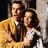 A red background displays a pixelated image of two people embracing on the left, with black text reading "Tonight, tonight it all began tonight. and the world went away..." below.