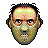 Pixel art of a humanoid face with greenish skin, glowing white eyes, and a balding head with dark hair on the sides, set against a solid gray background.