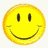 Yellow circular smiley face with black oval eyes and curved mouth on white background; purple-and-yellow swirl icon with 'Smile' text below it; blue abstract patterned shape.