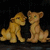 Two pixelated lion cubs sit side-by-side against a dark background, facing each other with neutral expressions.