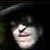 Static pixelated image of a person's face with dark hair and light skin, partially obscured by low resolution and compression artifacts.