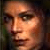 Pixelated close-up of a human face with warm lighting and brown hair, displayed as a static 50x50 buddy icon.
