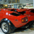 A red sports car icon displayed across three frames showing exterior, interior, and rear views with visible wheel, steering wheel, headlights, taillights, and side mirrors.