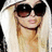 A pixelated image of a person with long blonde hair and dark sunglasses, next to green text on a blue background.