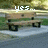 A pixelated outdoor scene with a wooden bench on a paved path, showing text changes