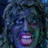 Pixelated image of a person with curly hair and a wide grin, surrounded by pixelated text in a