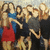 Pixelated group of five figures in varied attire with one red skirt, blue top, and dark clothing against a light background.