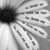 Black-and-white flower with text overlays; petals contain repeated small text, center dark, background light gray.