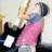 A pixelated image of a person in a pink sleeveless top and blue undershirt holding a guitar, with text reading "I LOVE HIM FOREVER!" on black background.