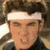 six showing a person with a white headband and dark hair, with changing text overlays in red, orange, yellow, and green