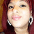 A person with red hair and large hoop earrings appears in a of four showing slight variations in head position