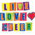 Pixelated text and a heart symbol arranged in three rows with colorful block backgrounds.