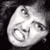 Pixelated grayscale image of a cartoonish face with exaggerated features on a black background, appearing as a static buddy icon.