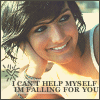 A static image shows a person with dark hair resting their head on a hand, wearing a white sleeveless top with a blue patterned strap, and text at the bottom reads "I CAN'T HELP MYSELF I'M FALLING FOR YOU".
