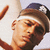 Pixelated close-up of a person with light skin wearing a white headband and dark hair tied back, holding an object near their face.