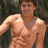 A pixelated image of a shirtless person with a muscular build standing against a blurred background, next to blue text reading "Zac Efron <3 <3" on a black background.