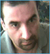 A person in a light gray shirt appears in two side-by-side frames with slight head movement against a blurred green background.