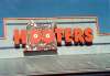 Static buddy icon featuring red text "HOOTERS" with a cartoonish mascot in front of a building facade, set against a blue sky background.