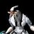 Pixelated static image of a figure with light-colored hair and clothing against dark background, showing partial facial features and upper body.