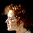 Pixelated side-profile portrait of a person with curly brown hair against black background, rendered in low-resolution 256x256 pixels with visible dithering and anti-aliasing artifacts.