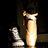 A four-quadrant image with a dark background showing a person in a white dress and a chess piece, paired with bright pink and gray sections containing text.