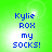 Green background with blue pixelated text reading 'Kylie ROX my SOCKS!' in four identical