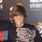 Pixelated image of a person with brown hair wearing dark clothing, next to cyan background with pixel-art text.