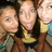 Three pixelated figures with light skin tones and brown hair, wearing yellow tops against a blurred background.