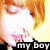 A pixelated image of a person with orange hair and closed eyes, wearing a black top with pink accents, holding an object near their mouth.