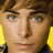 Pixelated close-up of a person's face with brown hair, blue eyes, and yellow shoulder accents against dark clothing.