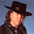 A 50x50 pixel buddy icon split into two sections: a person wearing a black cowboy hat and dark jacket on the left, and green text reading "Original Icons .com" on a dark green background on the right.