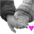 Two hands clasped in a gray-scale image with colorful heart icons changing below them across frames.