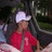 Pixelated figure in red shirt and white cowboy hat against dark green foliage background.