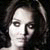 Pixelated grayscale portrait of a person with dark hair against black background, showing partial face and neck in close-up.