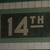 A static icon displays "14TH" in light gray numerals and letters on a dark background, bordered by green stripes above and below.