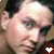 A pixelated close-up of a person's face with two heart symbols at the bottom, one white and one black.